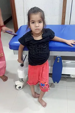 A child seated on an examination table