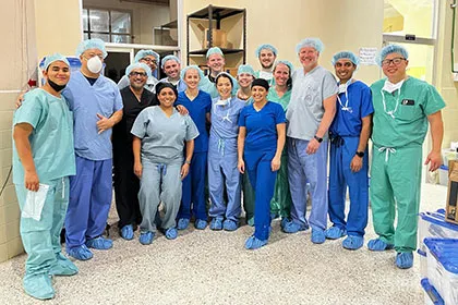 The Operation Footprint surgical team in scrubs and caps, gathered in a hospital corridor in Honduras